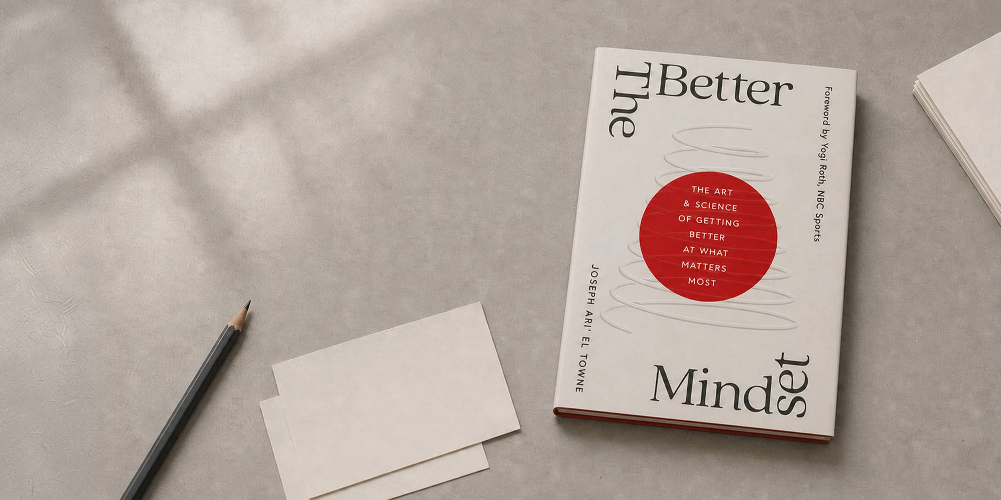 The Better Mindset book on a desk beside a pencil and blank notecards